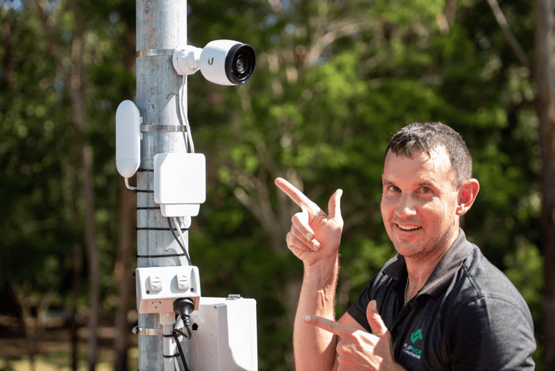 Man pointing at outdoors camera